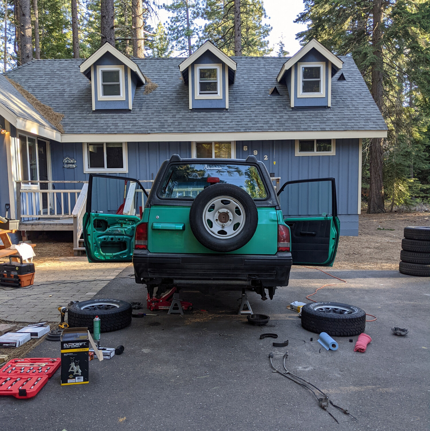 The Tracker getting its parking brake cables and rear drums and shoes replaced.